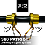 360° Patriot anti-wrap flagpole spinners with gold clamps and black shaft on a white background.